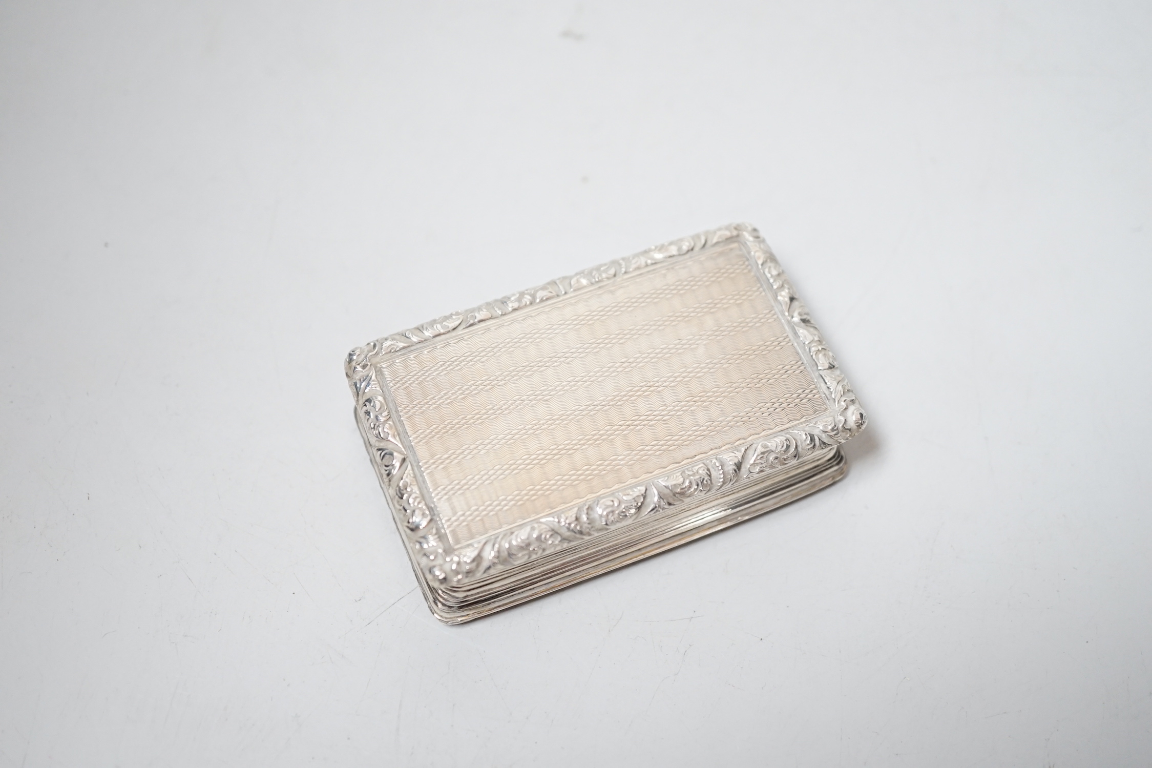 A George IV engine turned silver rectangular snuff box, with engraved inscription, Thomas Shaw?, Birmingham, 1823, 73mm.